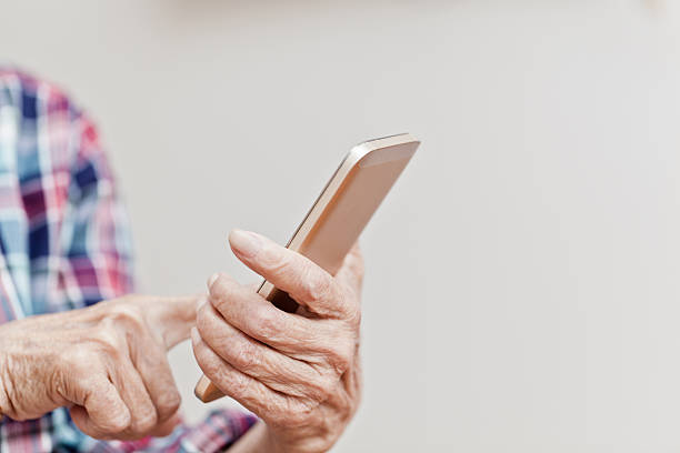 Old woman using mobile stock photo