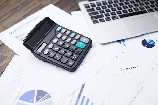 istock laptop and calculator on financial report 528431452