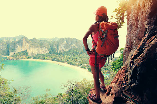 istock successful woman hiker enjoy the view on mountain top cliff 528432248