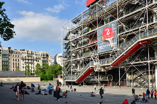 People relaxing at public space in front of Pompidou center Paris, France - May 13, 2015: People relaxing at public space in front of Centre of Georges Pompidou on May 13, 2015 in Paris, France. The Centre of Georges Pompidou is one of the most famous museums of the modern art in the world. pompidou center stock pictures, royalty-free photos & images