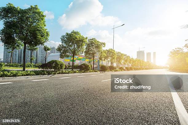 Empty Asphalt Road In Modern City At Sunrise Stock Photo - Download Image Now - City, Street, Road