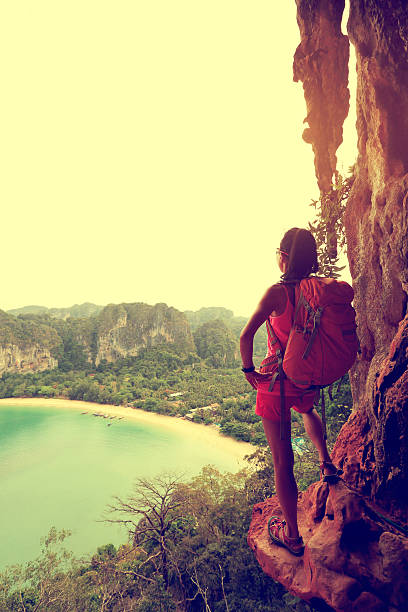 istock young woman backpacker hiking at seaside mountain cliff 528434854