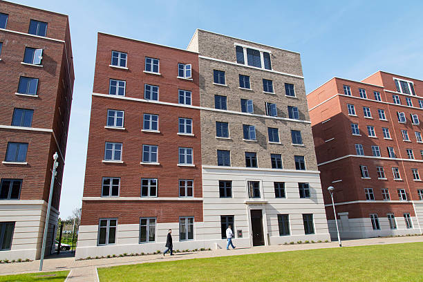 Swansea Bay Campus - Student Accommodation Swansea, UK: May 5, 2016: The magnificent new 65 acre Bay Campus is located right on the beach on the eastern approach to Swansea, and is the home to the College of Engineering and School of Management. Two students walk through the residential area.  swansea stock pictures, royalty-free photos & images