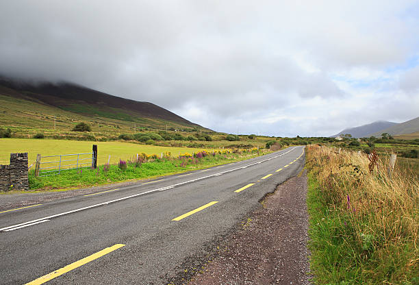 istock Road with clouds on the hills. 528439649