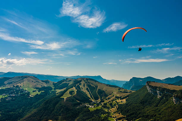 Paragliding on the sky Paraglider flies over the Dolomites to infinity paraglider stock pictures, royalty-free photos & images