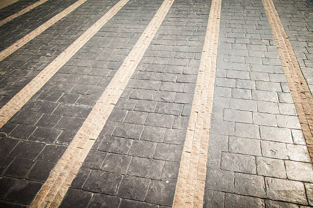 istock Black and yellow cobblestone walkway 528439982