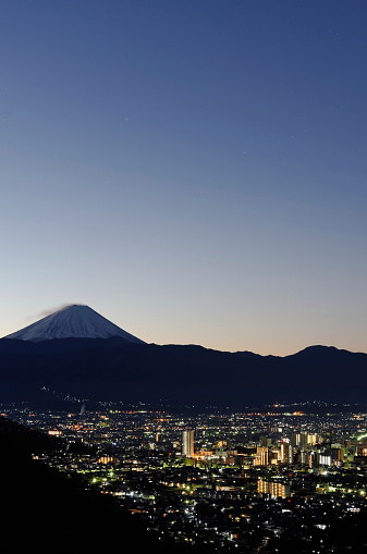 Kofu city photographed from high point view during twilight with Mt. Fuji in the background. ( winter season )