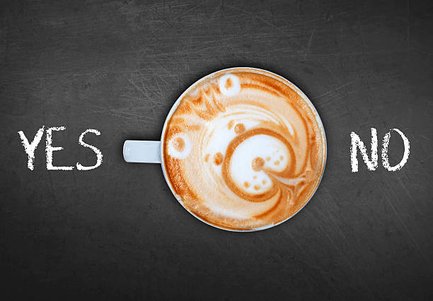 istock Cup of coffee on black board switching yes 528440296