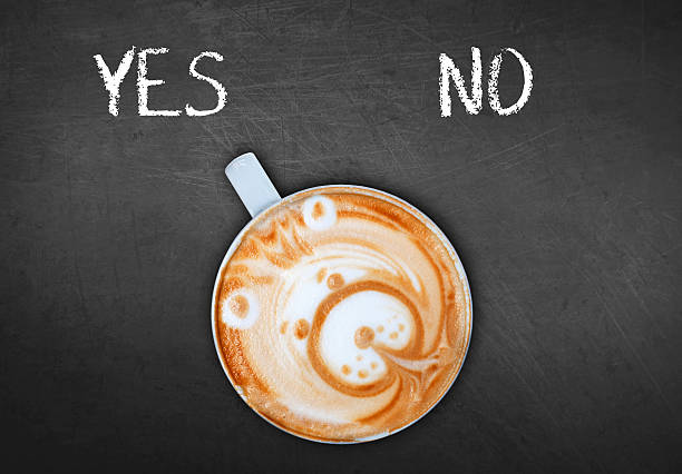 istock Cup of coffee on black board switching yes 528440610