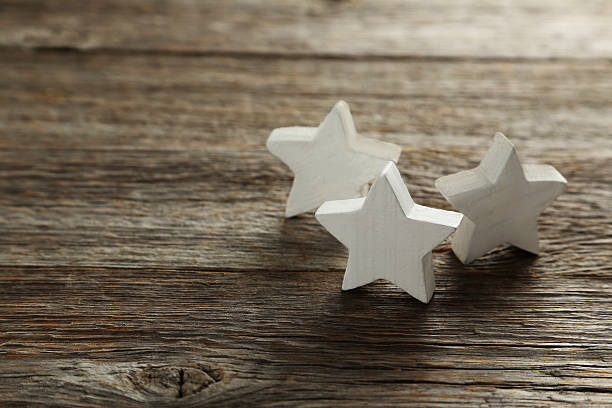 istock Decorative stars on a grey wooden background 528440624