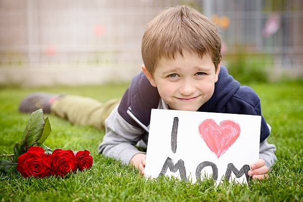 istock Boy giving his mother self-made greeting card 528441070