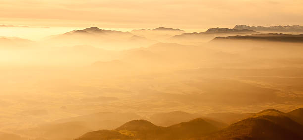 istock yellow foggy mountain landscape 528441986