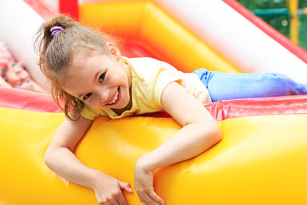 istock Joyful little girl playing on a trampoline. 528442143