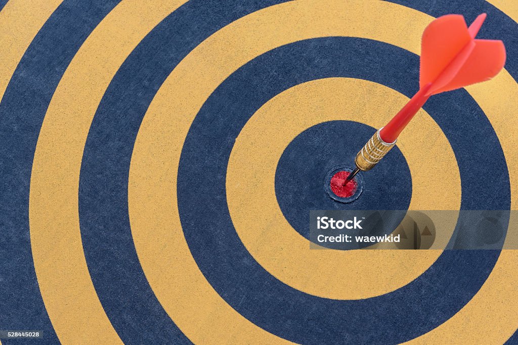 dart target with arrow on bullseye Dart target with arrow on bullseye, Goal target success business investment financial strategy concept, abstract background Efficiency Stock Photo