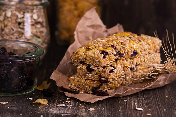 istock Granola bar with ingredients over wooden table 528445378