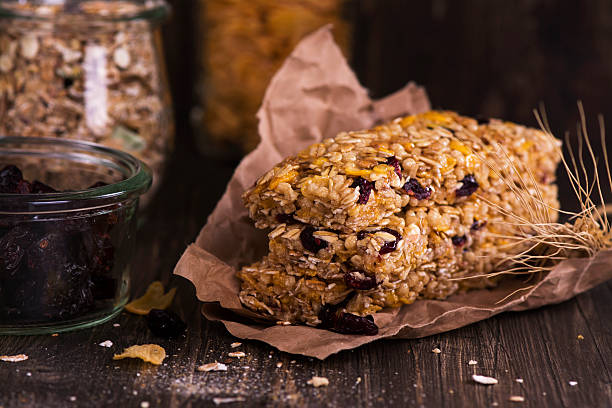 istock Granola bar with ingredients over wooden table 528445450