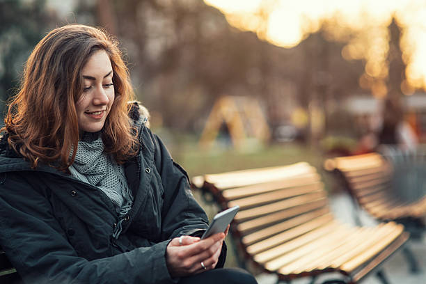 istock Young girl texting on smart phone 528445474