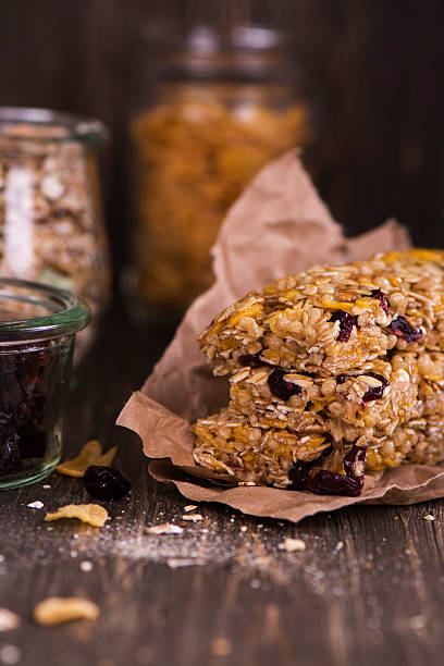 istock Granola bar with ingredients over wooden table 528445534