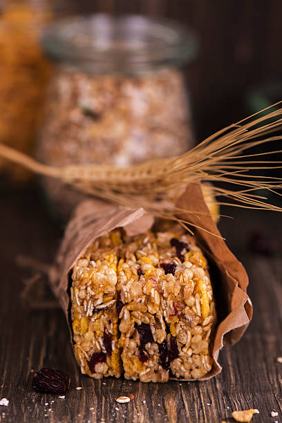 istock Granola bar with ingredients over wooden table 528445598