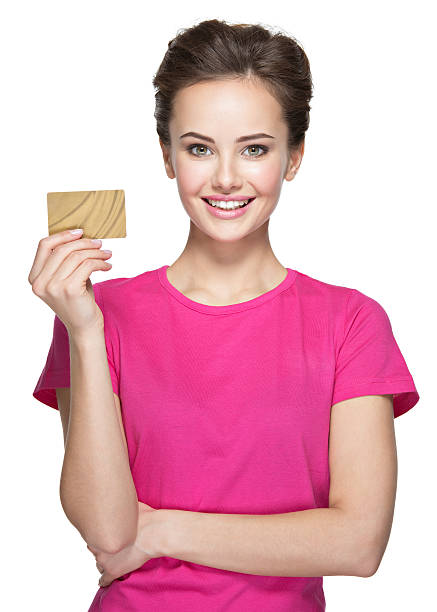 istock Young smiling woman holds credit card on white background 528446218