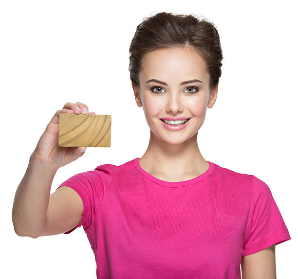 istock Young smiling woman holds credit card on white background 528446310