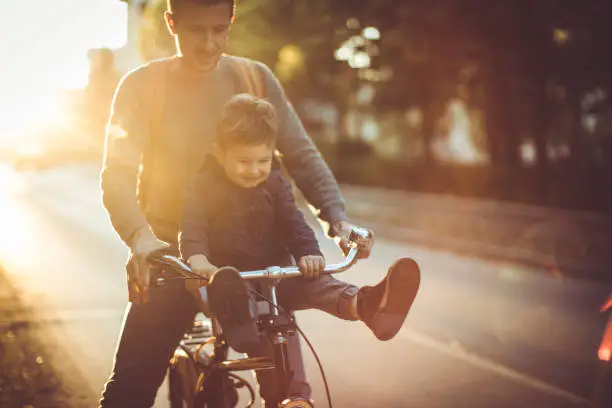 Photo of Young cyclist and his father