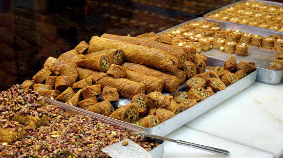 Delicious Turkish confectionery presented on trays at bakery.