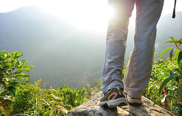 istock hiking feet mountain peak rock 528461665