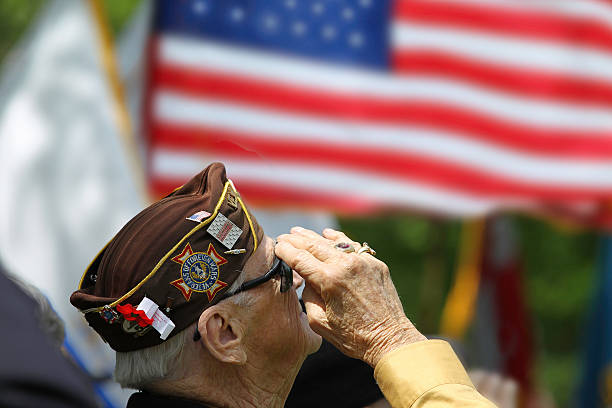 Veterans Saluting Veteran Salutes the US Flag military photos stock pictures, royalty-free photos & images