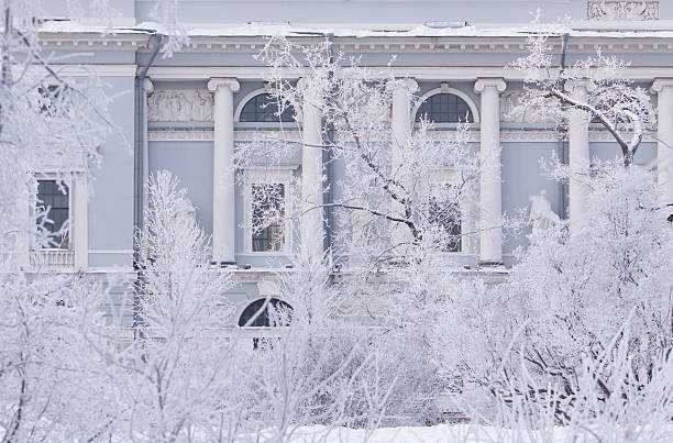 A wide, tranquil view of a park in Niagara Falls, Ontario, completely transformed by a heavy snowfall. The image features a thick blanket of pristine white snow covering the ground, with intricate tree branches and park benches heavily weighted down by fresh snow. This high-key, bright winter scene captures the quiet essence of a Canadian winter day. Ideal for seasonal backgrounds, nature themes, and winter tourism
