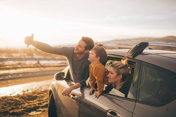 Making memories Photo of cute little family posing for the selfie in the nature, during their excursion with family car taken on mobile device photos stock pictures, royalty-free photos & images