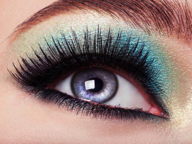 istock Woman eye with green make-up. Long eyelashes 528475610