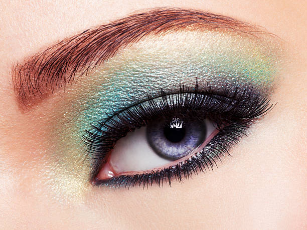 istock Woman eye with green make-up. Long eyelashes 528475728