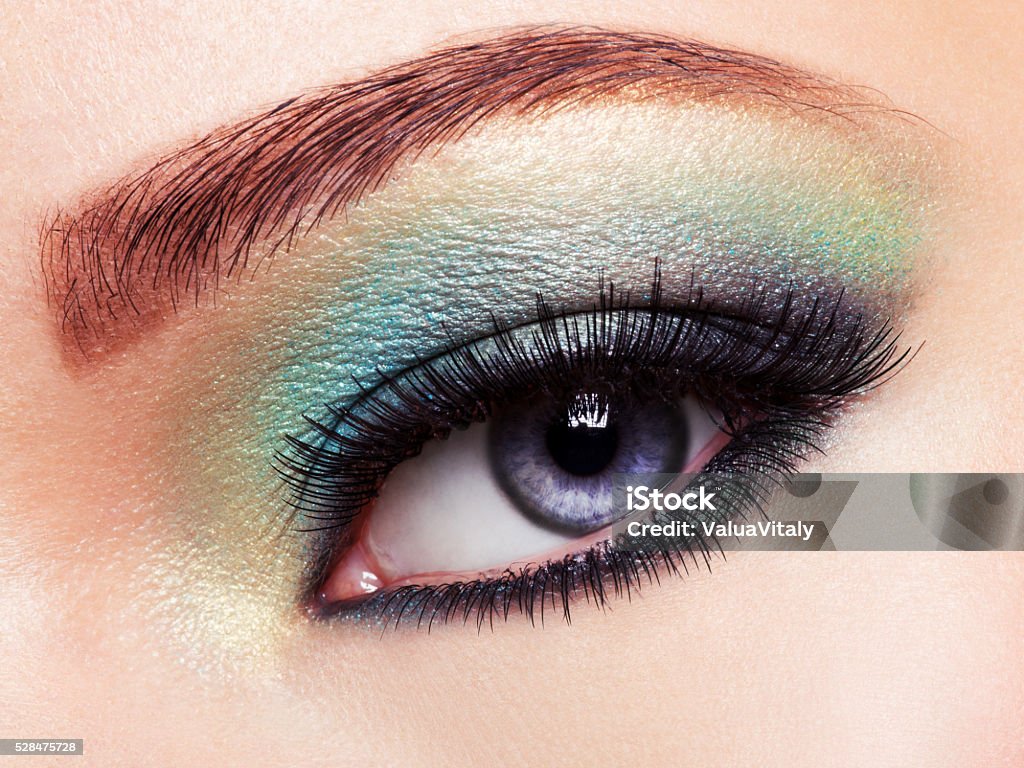 Woman eye with green make-up. Long eyelashes Woman's eye with green eye make-up. Long eyelashes Adult Stock Photo
