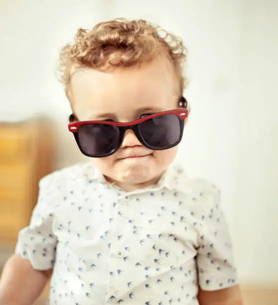 Photo of Little boy with oversized sunglasses