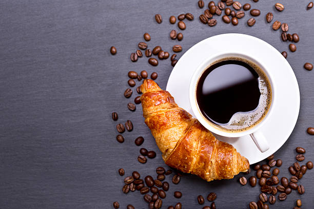 istock cup of coffee with croissant 528476380