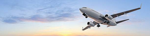 istock modern passenger airplane - flight in sunset panorama 528478026