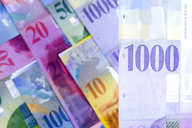 istock swiss francs lying on a white background 528478684