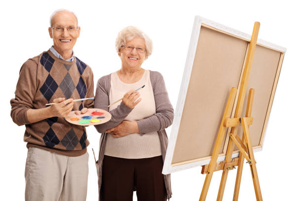 istock Elderly couple posing next to a canvas 528480686
