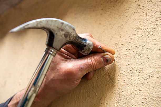 Man Hammering Nail Into Wall Stock Photos, Pictures & Royalty-Free Images - iStock Man Hammering Nail Into Wall Stock Photos, Pictures & Royalty-Free Images - iStock