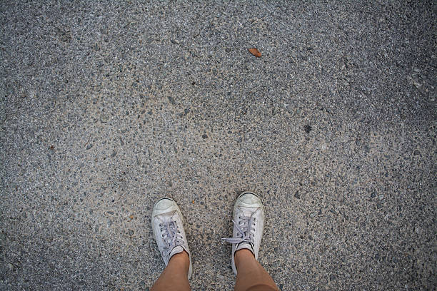 istock Human stands on small stones flooring 528482090