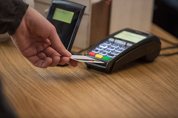 istock Man at counter paying with credit card 528482296