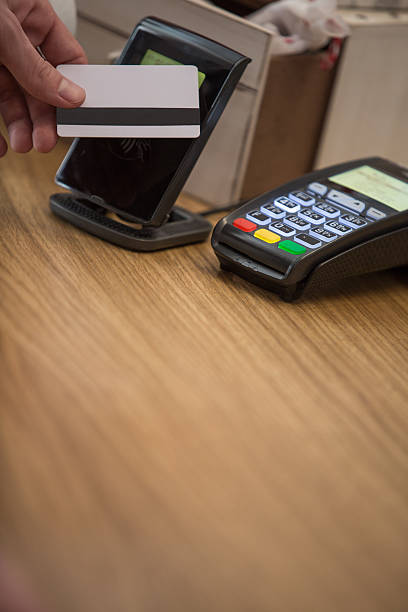 istock Man at counter paying with credit card 528482376
