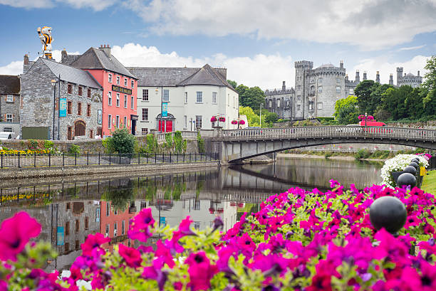 flower lined riverside view of kilkenny stock photo