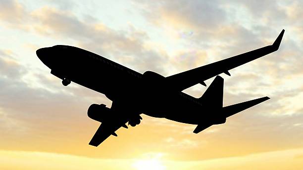 istock siluette of a modern passenger airplane takeoff in the sunset 528484694