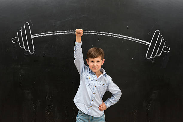 istock cute little boy rising drawn barbell on finger 528485184