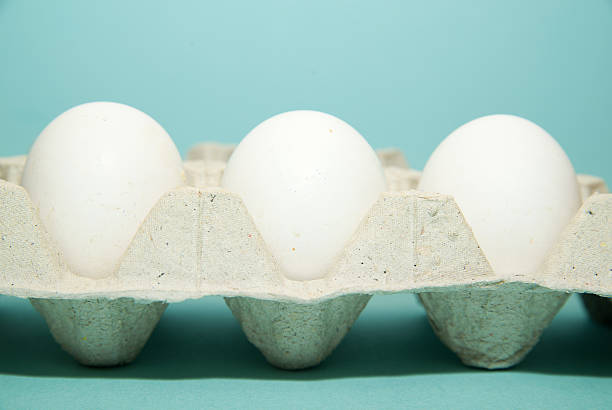 istock Chicken eggs in the package for sale on blue surfase 528485606
