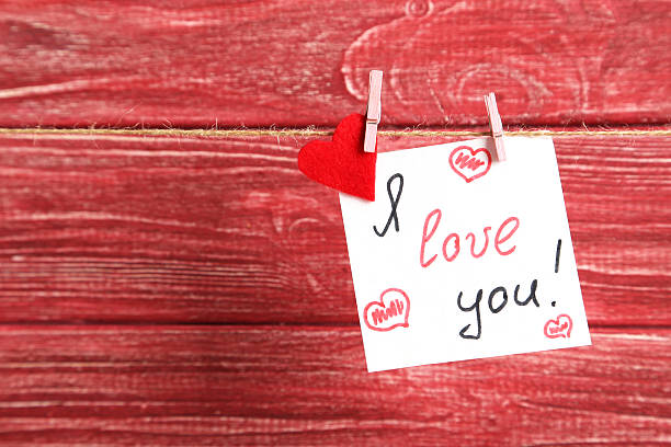 istock Paper and red heart hanging on rope 528486416