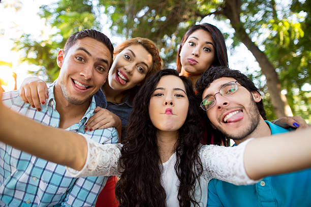 istock Group of Hispanic friends making faces 528489762