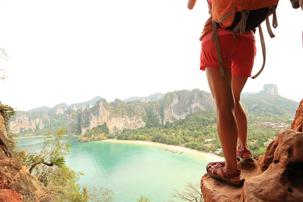 istock young woman backpacker hiking at seaside mountain cliff 528490638